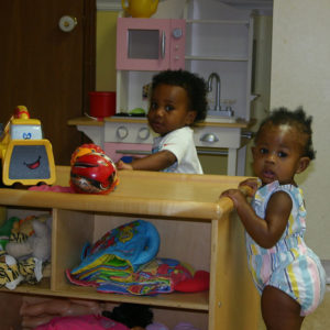 Babies in infant & Toddler Daycare holding onto furniture to stand